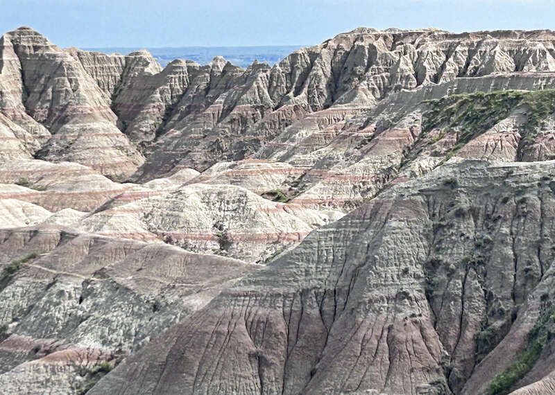 The White River Badlands of South Dakota consist of a scenic landscape of differentially weathered and eroded, nonmarine sedimentary rocks of Tertiary age.  The most visually-striking areas have been set aside as an American national park