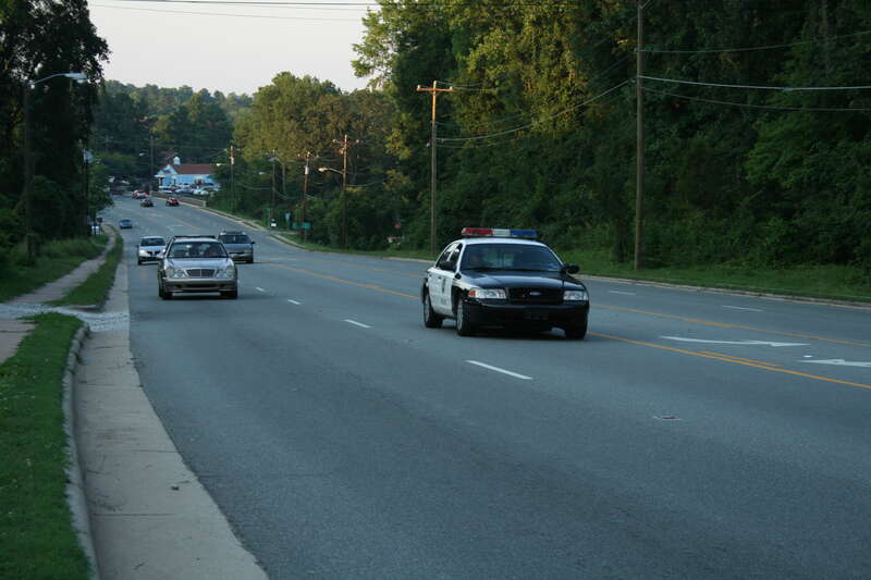 Chapel Hill, North Carolina police cruiser leading the uphill traffic on Franklin St in the evening.