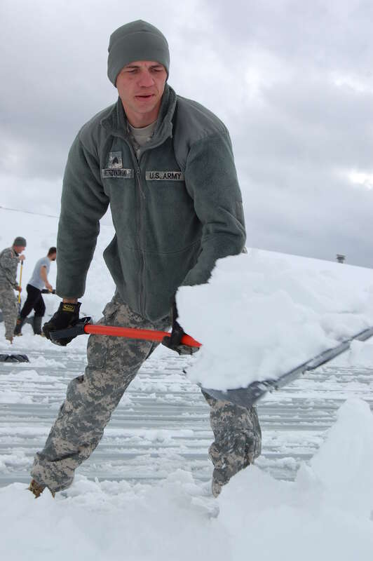 Sgt. Jeff Wietrzykowski, a carpenter with the 115 Engineering Battalion out of Clarksburg, W.Va., shovels six foot snow mounds from the roof of the Davis Volunteer Fire Department. Klepitch, member of the W.Va. CERFP team, or Chemical, Biological,
