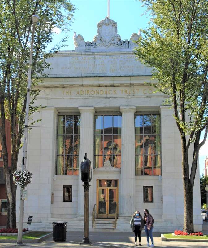 The Adirondack Trust Co, Buildingl located at 473 Broadway in Saratoga Springs, New York, was built in 1916 and was designed by Alfred Hopkins in the Beaux-Arts style.  It features bronze doors and chandeliers designed by Tiffany. The building is