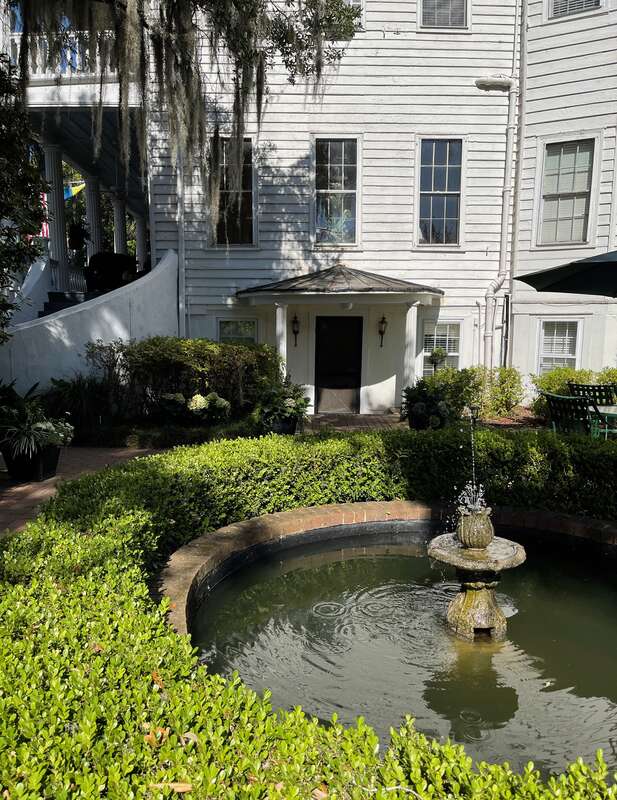 Side view with water fountain of the Rhett House Inn, Beaufort, South Carolina, USA.