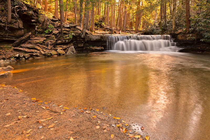 Long exposure waterfall from Swallow Falls State Park in Maryland, USA. HDR composite from multiple exposures. 
For those who might want to use this photo for editorial purposes, please note the waterfall &amp;amp; stepping stones face the opposite