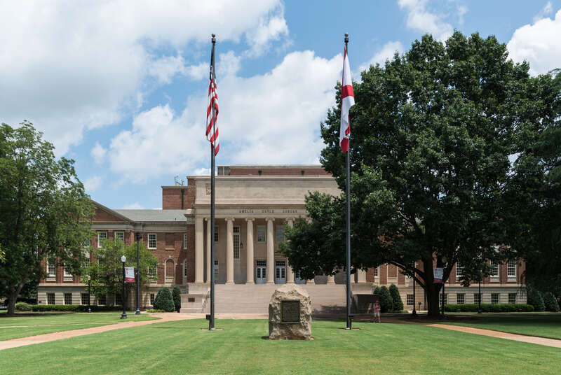 A south view of Amelia Gayle Gorgas Library, flags and a confederacy memorial, located on the campus of the University of Alabama, Tuscaloosa