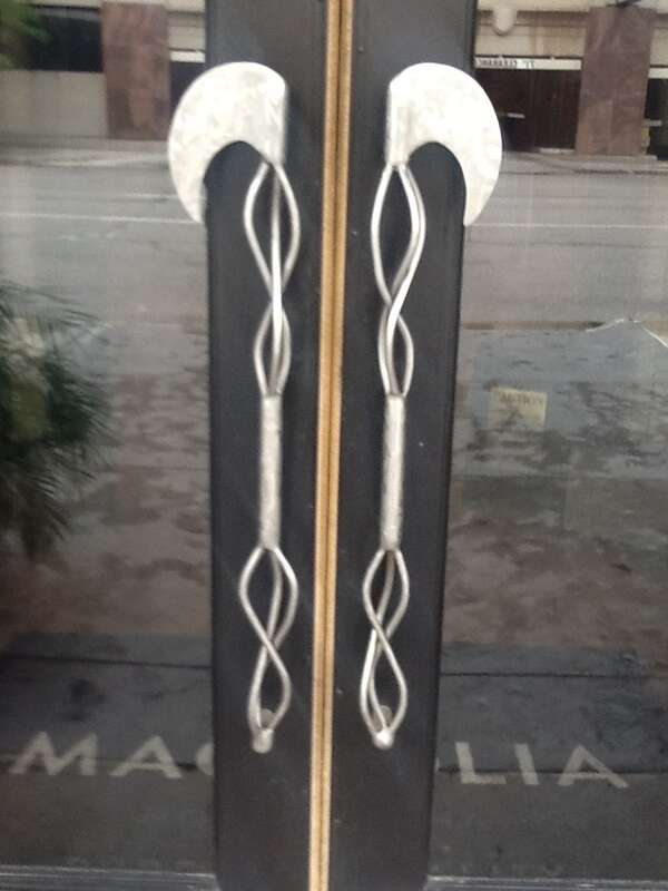 Door handles on the front door of the Aquila Court Building, now known as the Magnolia Hotel.