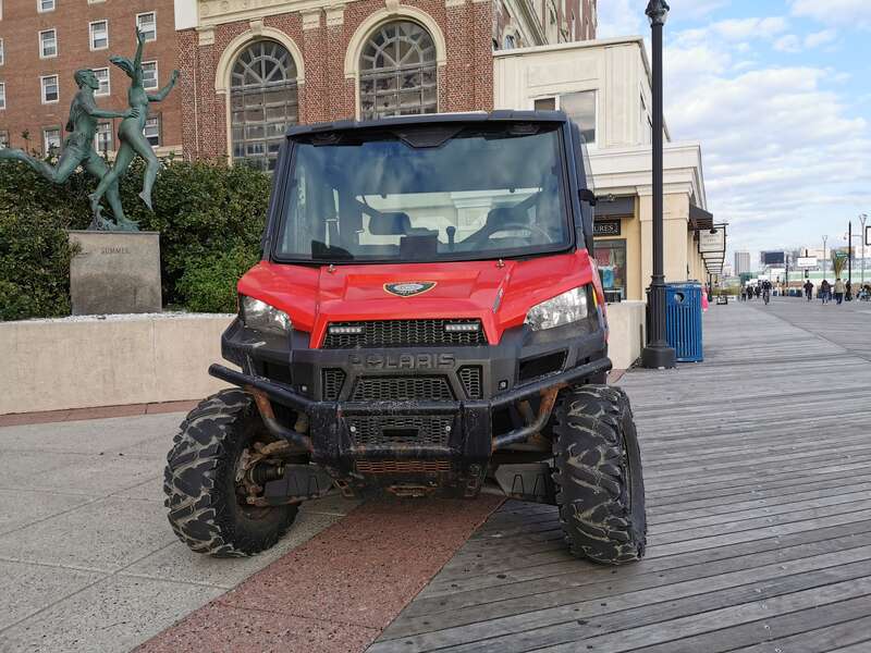 A Polaris Ranger Crew 900 EFI DOHC all-terrain vehicle patrols the Atlantic City Boardwalk under the authority of the Atlantic City Police Department. (Front view.)
The sculpture  “Summer” by Anthony Frudakis and the Tropicana casino are visible in