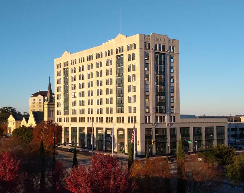 Renovated Montgomery Building at sunset as seen from a nearby parking deck in November 2018.