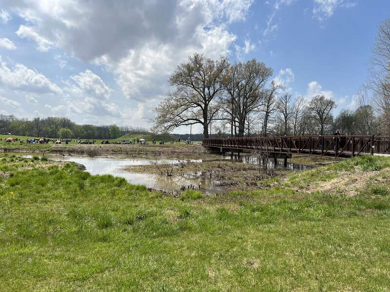 Mound A as seen from the Angel Mounds State Historic Site visitor center by the bridge. Note the people in the background gathered to watch the Total Solar Eclipse of April 8, 2024.