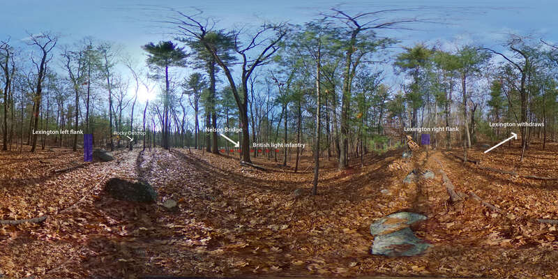 360 panoramic image of a wooded area on elevated ground looking toward a lower area. Text and image enhancements include, to the left, a blue rectangle and white text that says Lexington left flank. To the right of that white text says Rocky Outcrop