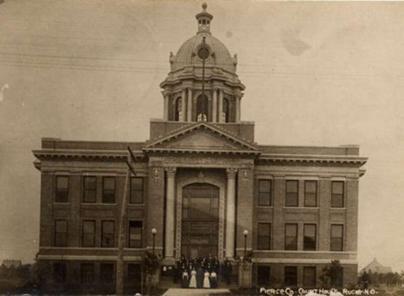 Gelatin silver print photographic postcard of Pierce County Courthouse, Rugby, S.D.  Per notation at NDSU Institute for Regional Studies web site, the image is from a postcard postmarked October 14, 1913.  Accordingly, the image is in the public
