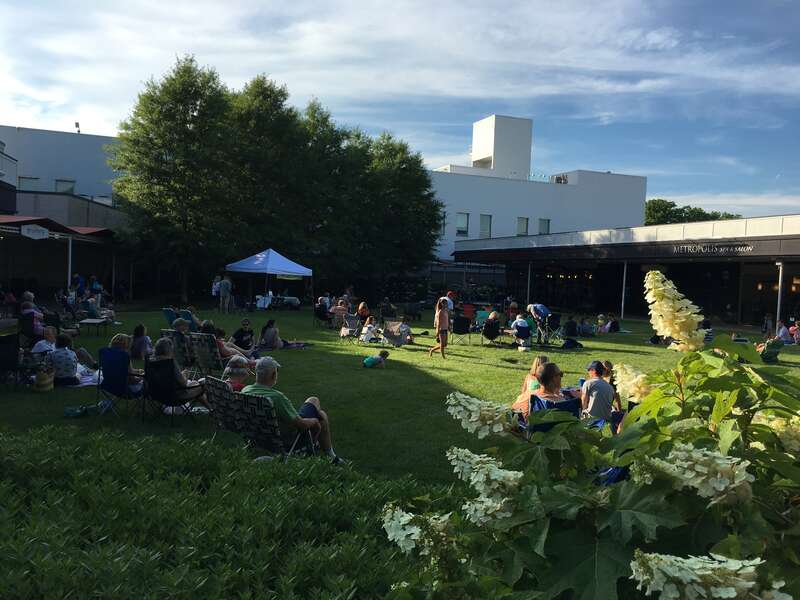 Northernmost portion of the central courtyard of the Princeton Shopping Center on North Harrison Street in Princeton, New Jersey.  A weekly Thursday evening concert is taking place, in this case featuring The Dirk Quinn Band, with people camped out