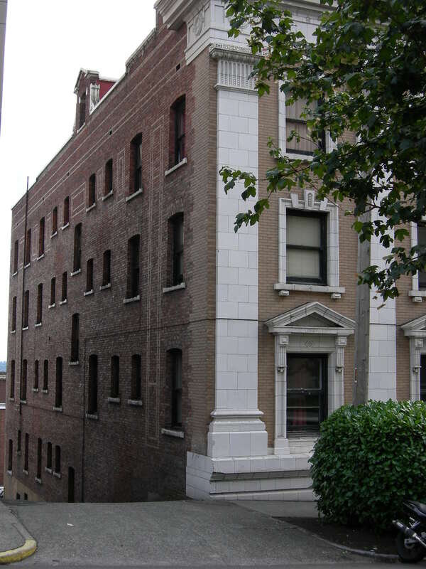 De La Mar Apartments, 115 W. Olympic Pl., Lower Queen Anne, Seattle, Washington, USA. The 1909 apartment building is listed on the National Register of Historic Places, ID #80004001. The angle here is chosen to show the alley-facing side of the
