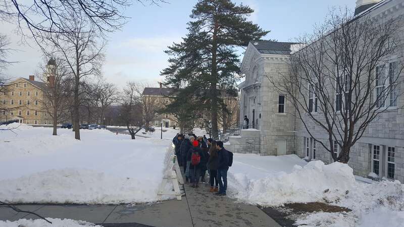 Students wait in line outside the McCullough student center at Middlebury College to watch Edward Snowden speak