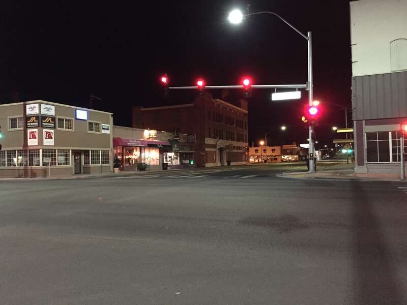View east along Fifth Street (Nevada State Route 227) at Idaho Street (Nevada State Route 535 and Interstate 80 Business) at night in Elko, Nevada