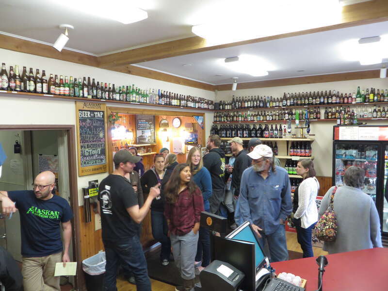 View inside the small shop / taproom of the Alaskan Brewing Company in Juneau, Alaska.

Visitors get six free tastings out of ten beers on tap, the bar with the taps is hidden by the people standing in the corner of the room.