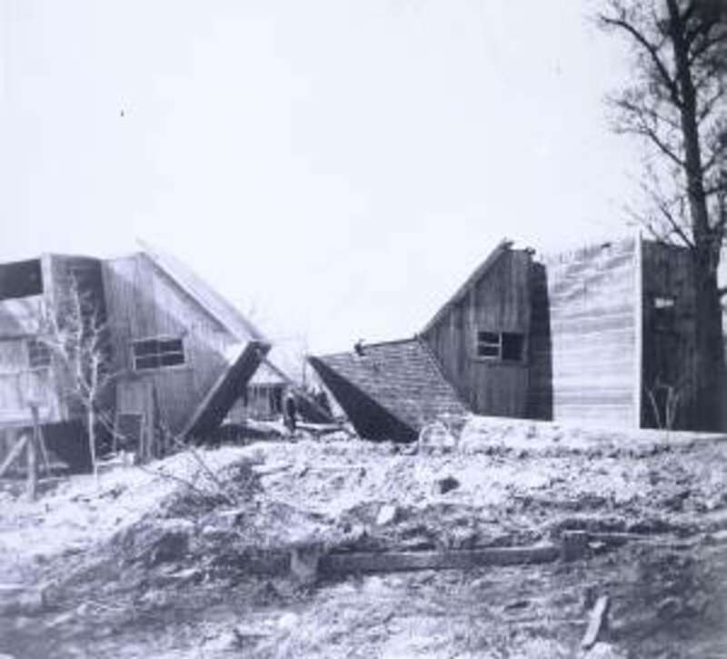 Two houses which were damaged in the 1897 flood of the Red River.  The image was taken from Front Street looking south.