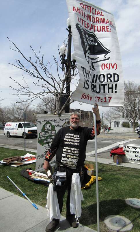 A Christian protester on the street of Temple Square, presenting the King James Version of the Bible as &quot;official anti-Mormon literature&quot;.
