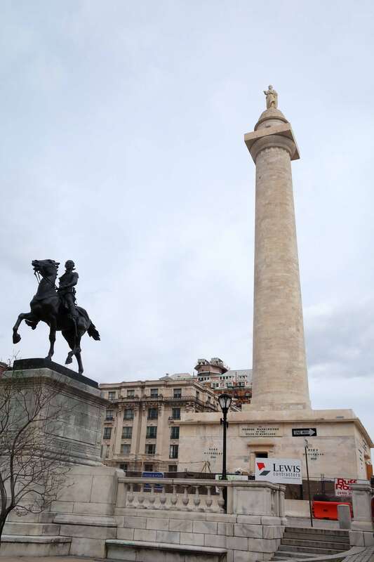A view of the George Washington Monument and the Lafayette Statue in the Mount Vernon Place Historic District of Baltimore