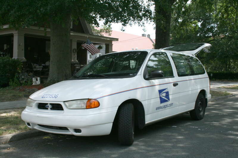 United States Postal Service Ford Windstar mail delivery van parked on Watts Street in Durham, North Carolina.