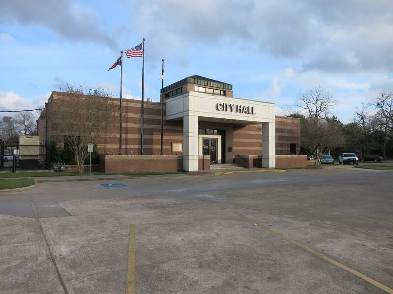 Photo shows Angleton City Hall at 121 S Velasco St, Angleton, TX 77515. View is toward the southeast.