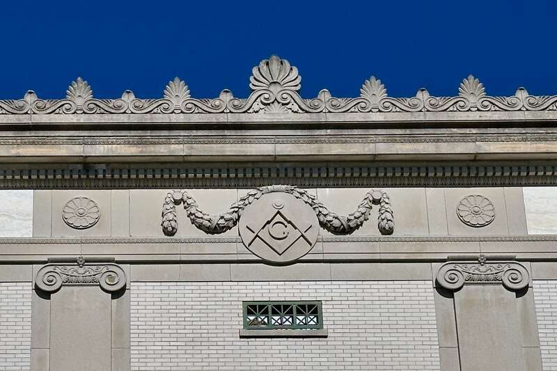 Architectural detail of the Plainfield Masonic Temple in Plainfield, New Jersey. Features the Square and Compasses symbol adorned with a festoon.
