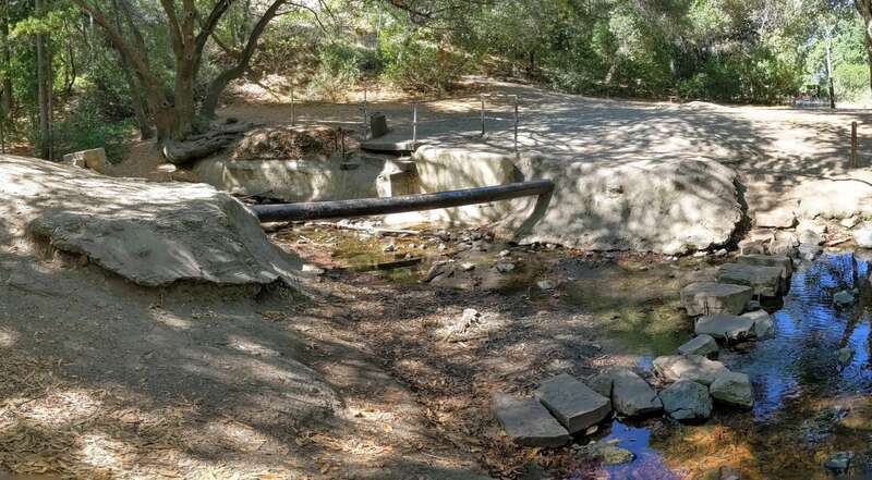 Arroyo Ojo de Agua, major tributary of Redwood Creek, where a pipe crosses it in Stulsaft Park, Redwood City, California