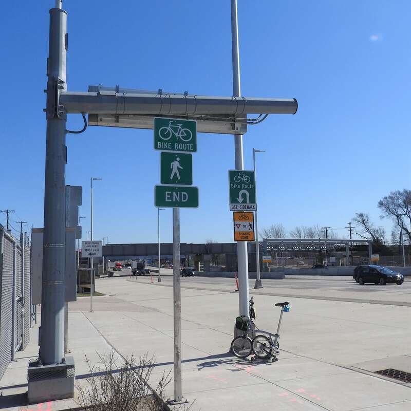 Looking southeast at turn onto Goethals Road on a sunny midday