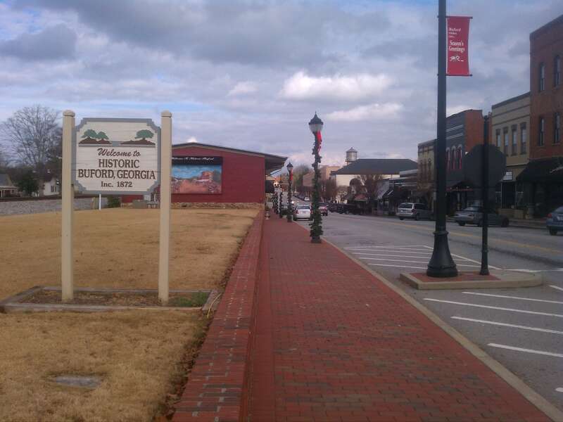 A photo of Main Street in Buford, Georgia including a &quot;Welcome to Historic Buford, Georgia&quot; sign.