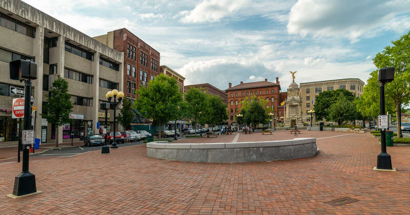 Central Park, Downtown New Britain, Connecticut. City Hall at center and Civil War Memorial with winged statue.