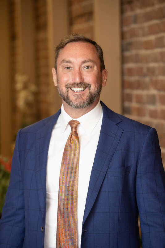 Photo of criminal defense attorney Joseph M. Tully standing in his Martinez, CA office. Photographed June 2022.