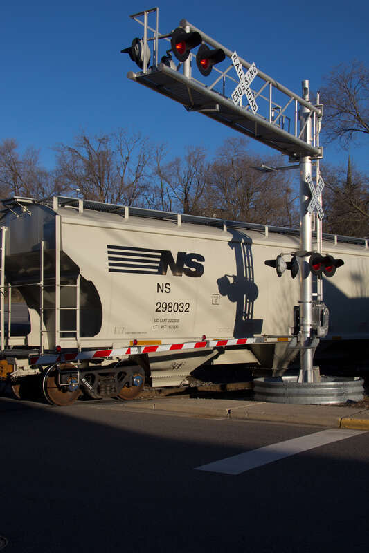 Brand new grain hoppers were on NS 44T as it crossed Bruce Street in Harrisonburg, Virginia.