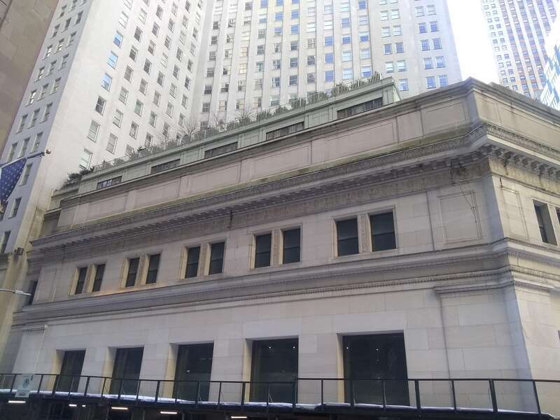 23 Wall Street (foreground) and 15 Broad Street (background) in the Financial District of Manhattan, New York, seen in February 2021 from Federal Hall.