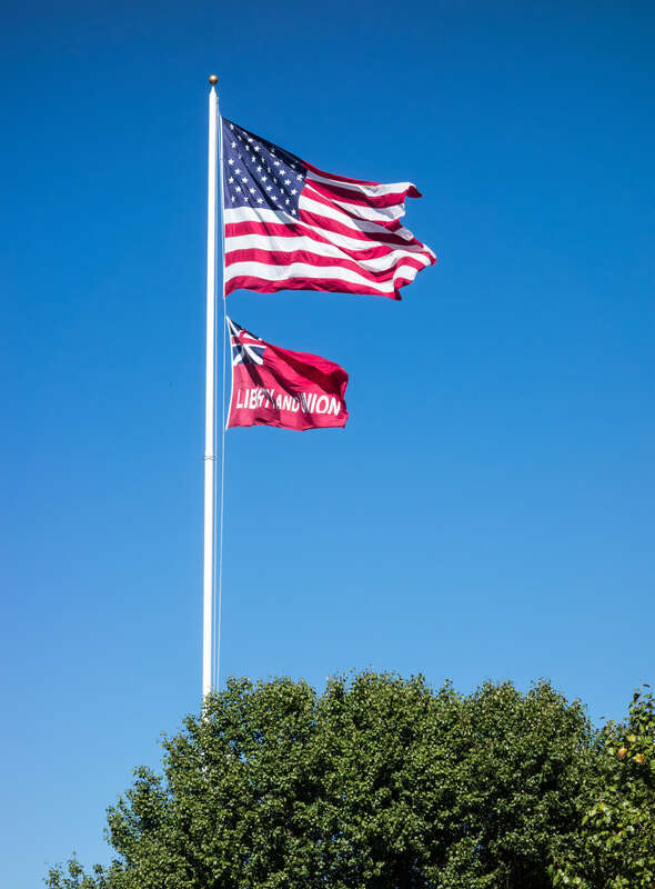 The flag of Taunton flies alongside the flag of the United States over Taunton Green in September 2016.