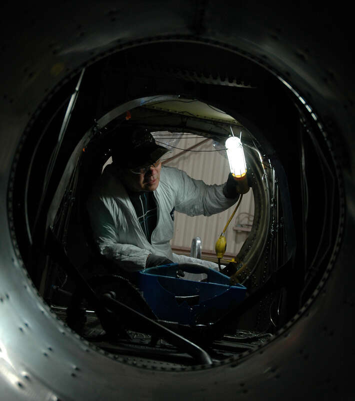 SAN DIEGO (Jan. 28, 2011) Hoang Danh, from Vietnam, a Naval Aviation Depot (NADEP) employee, inspects for corrosion while replacing the engine nacelle heat shield on a C-2A Greyhound Carrier On-Board Delivery aircraft at Naval Air Station North
