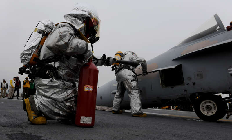 BREMERTON, WASH. (Jan. 11, 2011) Aviation Boatswain's Mate (Handling) Airman  Kyle Busch, left, from Evansville, Ind., and Aviation Boatswain's Mate (Handling) Airman Abel Cholico, from Reno, Nev., perform overhaul on an F/A-18 Hornet during a fire