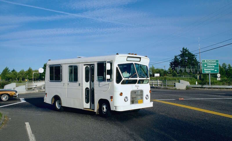 TriMet minibus No. 69, a &quot;Flxette&quot; model (manufactured by the Flxible Company), in service on a short-lived, unnumbered TriMet route between the Cedar Hills Transit Center and the Oregon Graduate Center, via Tanasbourne Mall. The minibus is turning