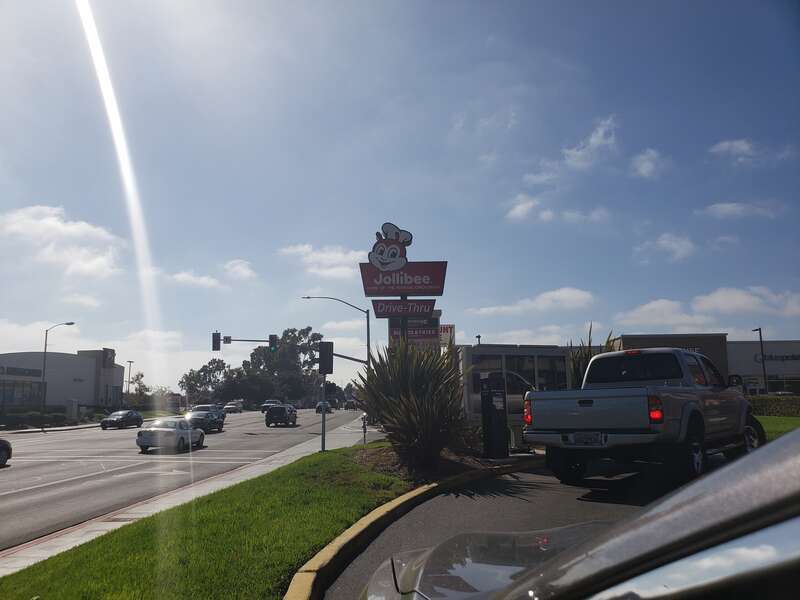 The street sign for the Jollibee in National City as seen from the drive thru