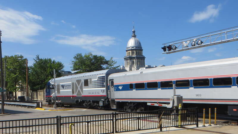 A southbound Lincoln Service train blocking Washington Street while stopped at Springfield station in July 2019
