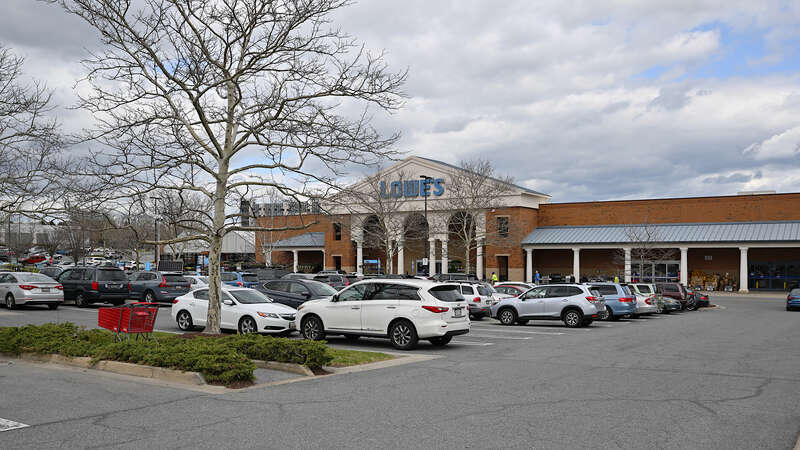 The Lowe's home improvement store in the Kentlands Market Square shopping center with a parking lot full of cars.  Kentlands neighborhood, Gaithersburg, Maryland.