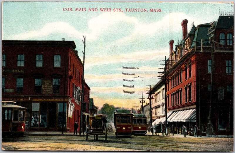 Divided back postcard of the intersection of Main Street and Weir Street in Taunton, Massachusetts, next to Taunton Green. The streetcars at center are on the line to Fall River.
