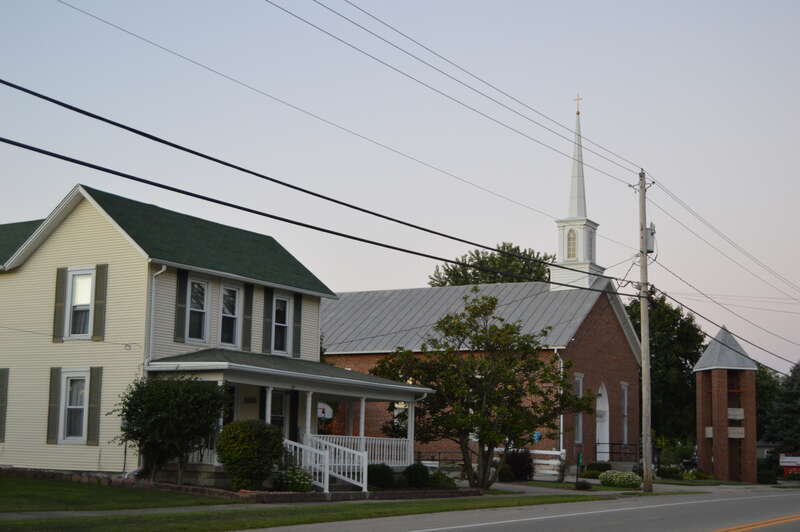A house and the Donnelsville Lutheran Church, located on Main Street (U.S. Route 40) just west of the School Street intersection in Donnelsville, Ohio, United States.