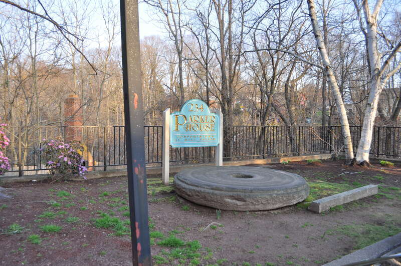 Millstone behind Mill A, Wilcox, Crittenden Mill, South Main, Middletown, Connecticut, USA.