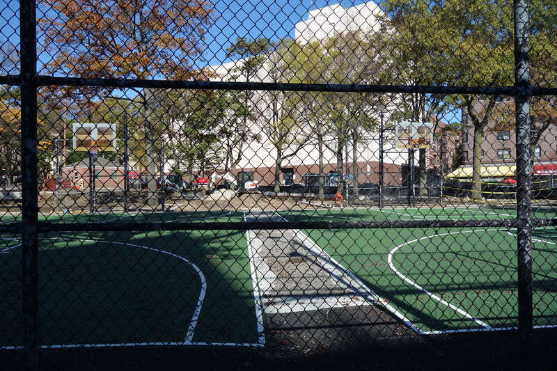 Looking into the basketball courts at the south end of Clement Clarke Moore Homestead Playground, on 45th Avenue between Broadway and 82nd Street in Elmhurst, Queens. The entire park is undergoing a major reconstruction project. Note that although