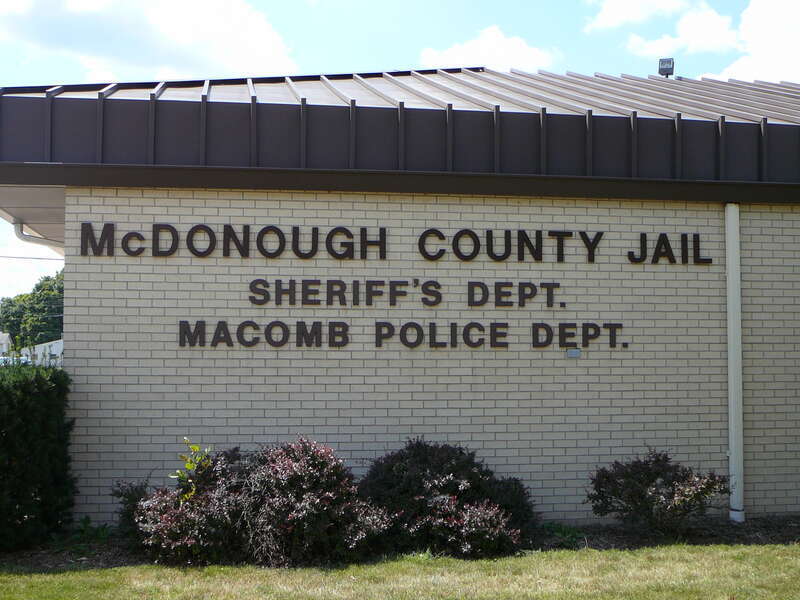 Picture of North facing exterior sign to the Macomb Police Department, E-911 Center, and McDonough County Sheriffs Department Combined Operations Center as taken from the North side of West Jackson St, in the city of Macomb, Illinois, 61455