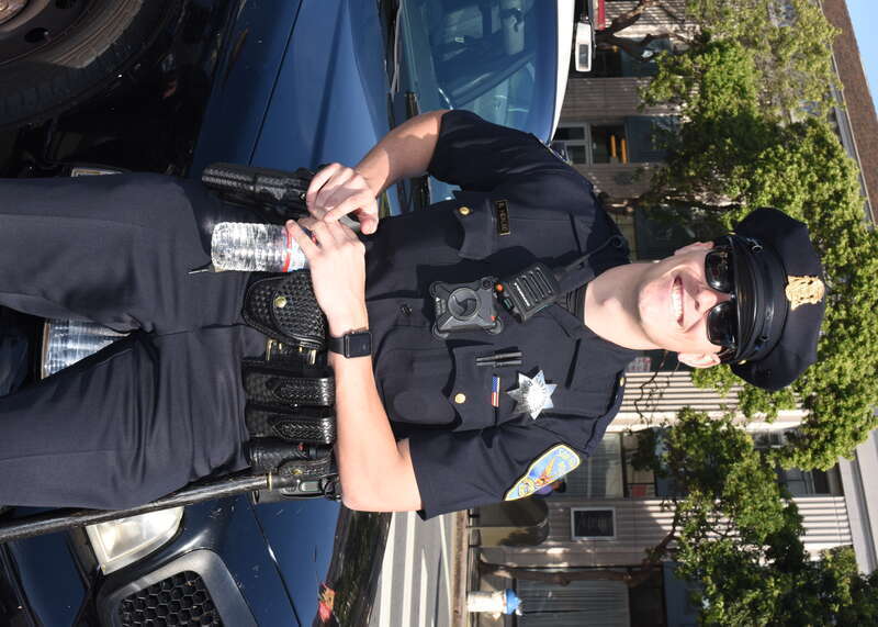 Officer B Hidalgo agrees to pose for a photo while leaning against his squad car on Harrison Street at Ninth Street during the 2019 Folsom Street Fair event.

YDD_1812_cr