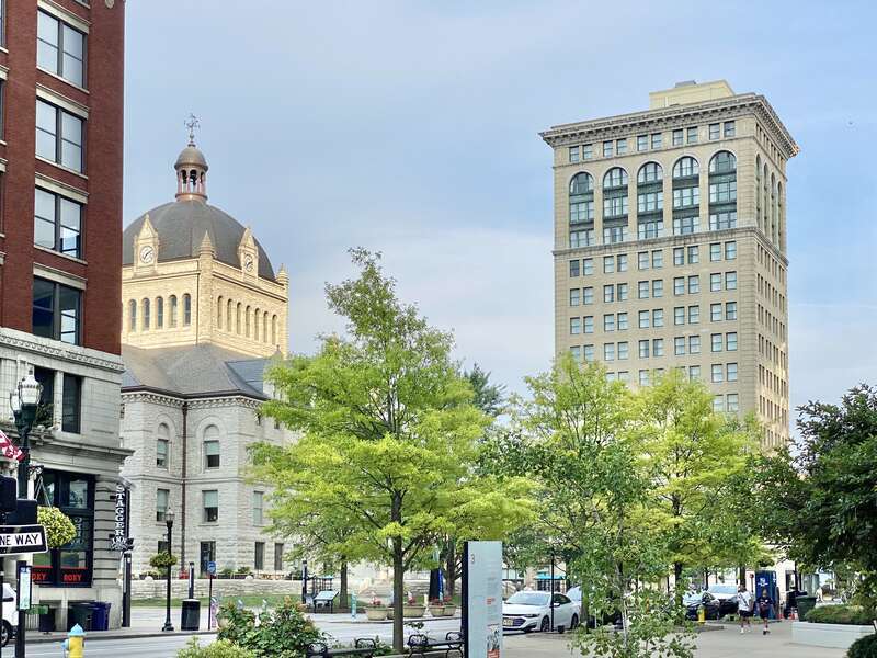 On the left, built in 1898-1900, this Richardsonian Romanesque Revival-style building was designed by Lehman and Schmitt to serve as the Fayette County Courthouse, and is the fifth courthouse to serve Fayette County, replacing a previous courthouse,