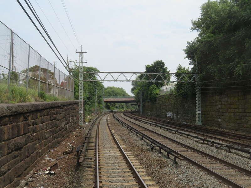 Old catenary poles in Mount Vernon viewed from the rear of a Grand Central-bound New Haven Line train in July 2019. The catenary poles in this section have been disused since the 1990s, when catenary was cut back from Woodlawn to near Pelham.