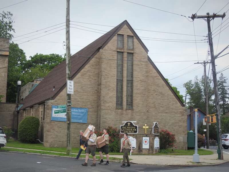 Looking south across Forest Avenue at church, as Boy Scouts pass on a cloudy Memorial Day