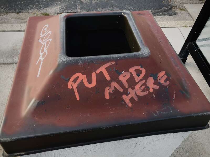 Vandalized trash can that reads &quot;Put  here&quot;, found near George Floyd Square