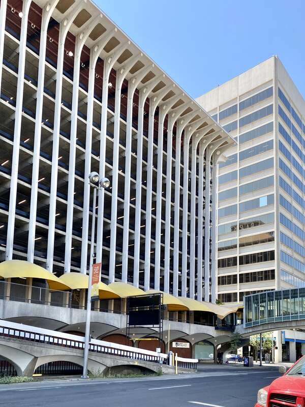Built in 1967, this Brutalist building was designed by Warren C. Heylman to serve as a parking garage, known as Parkade Plaza.  The building features a concrete structure, exterior fins with flared brackets at the cornice, vaulted ceilings below the