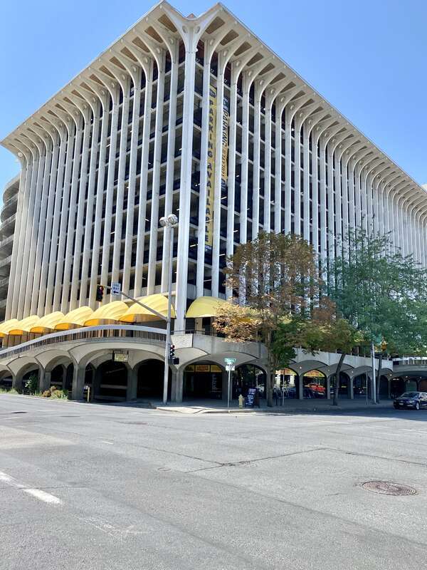 Built in 1967, this Brutalist building was designed by Warren C. Heylman to serve as a parking garage, known as Parkade Plaza.  The building features a concrete structure, exterior fins with flared brackets at the cornice, vaulted ceilings below the